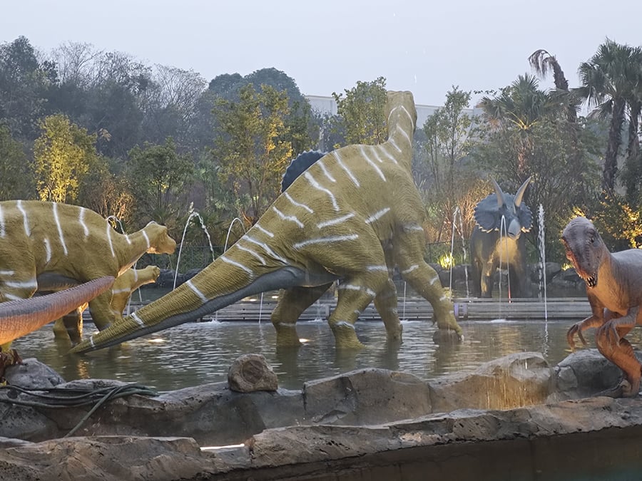 Group of Dinosaurs by the Pond